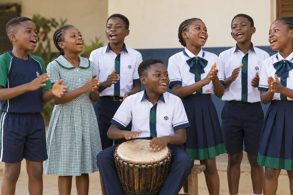 Pupils performing music and drama on stage